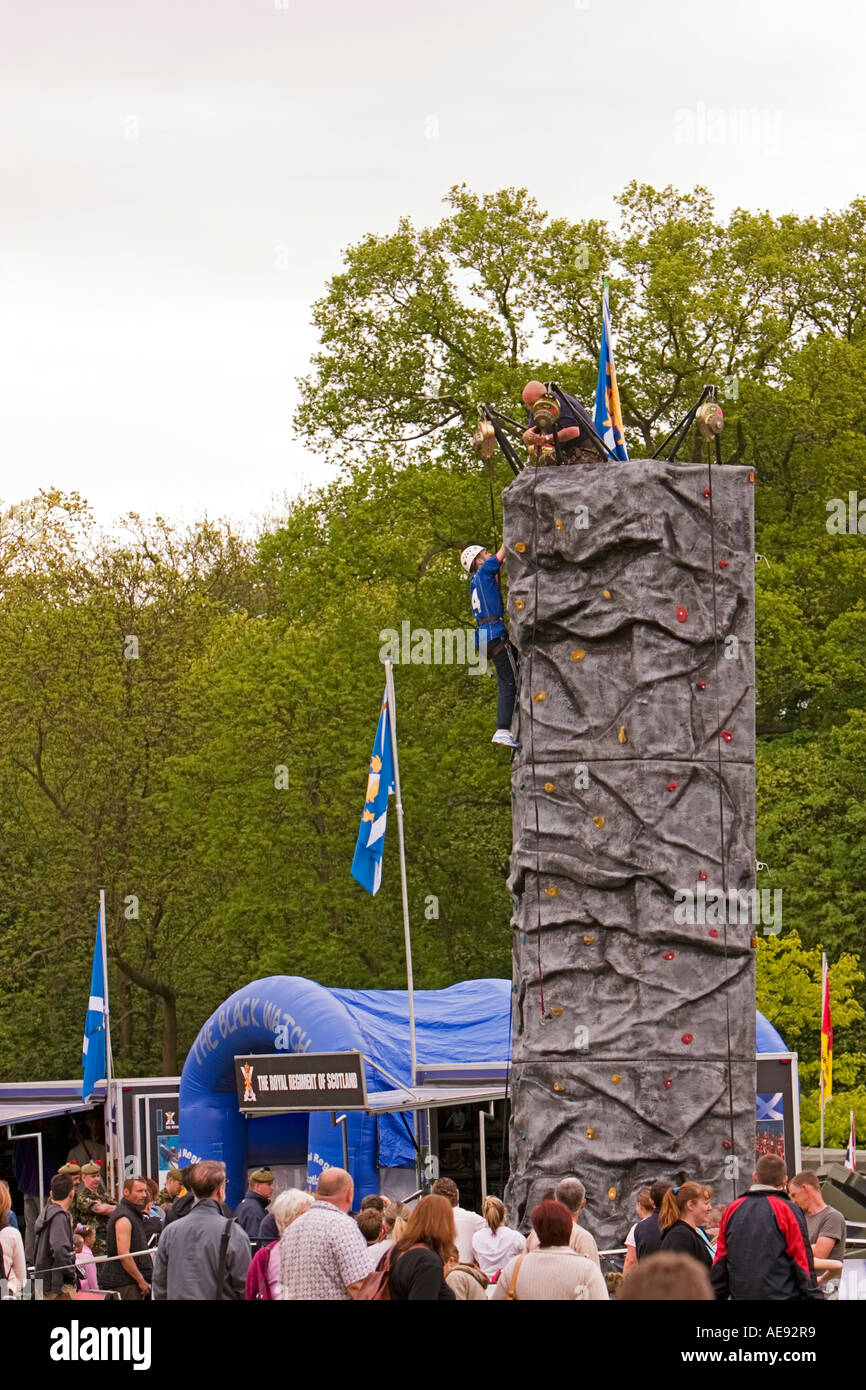 Boy on Army rock climbing wall at fun day in Dundee, Scotland Stock Photo