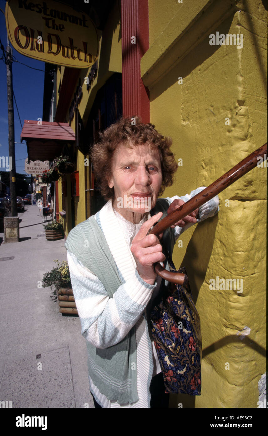 Old lady with walking stick hi-res stock photography and images - Alamy