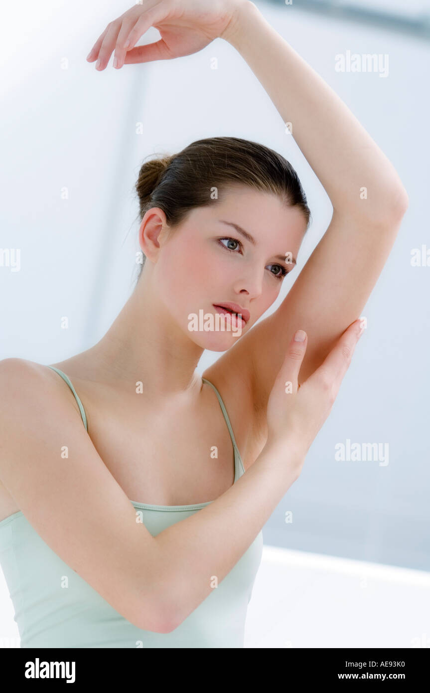 Woman touching her arm, Indoors Stock Photo Alamy