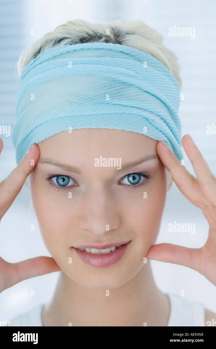 Young woman fingers on temples hi-res stock photography and images - Alamy