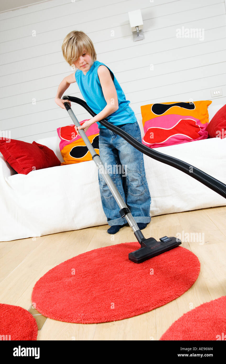 Young boy with vacuum cleaner Stock Photo Alamy