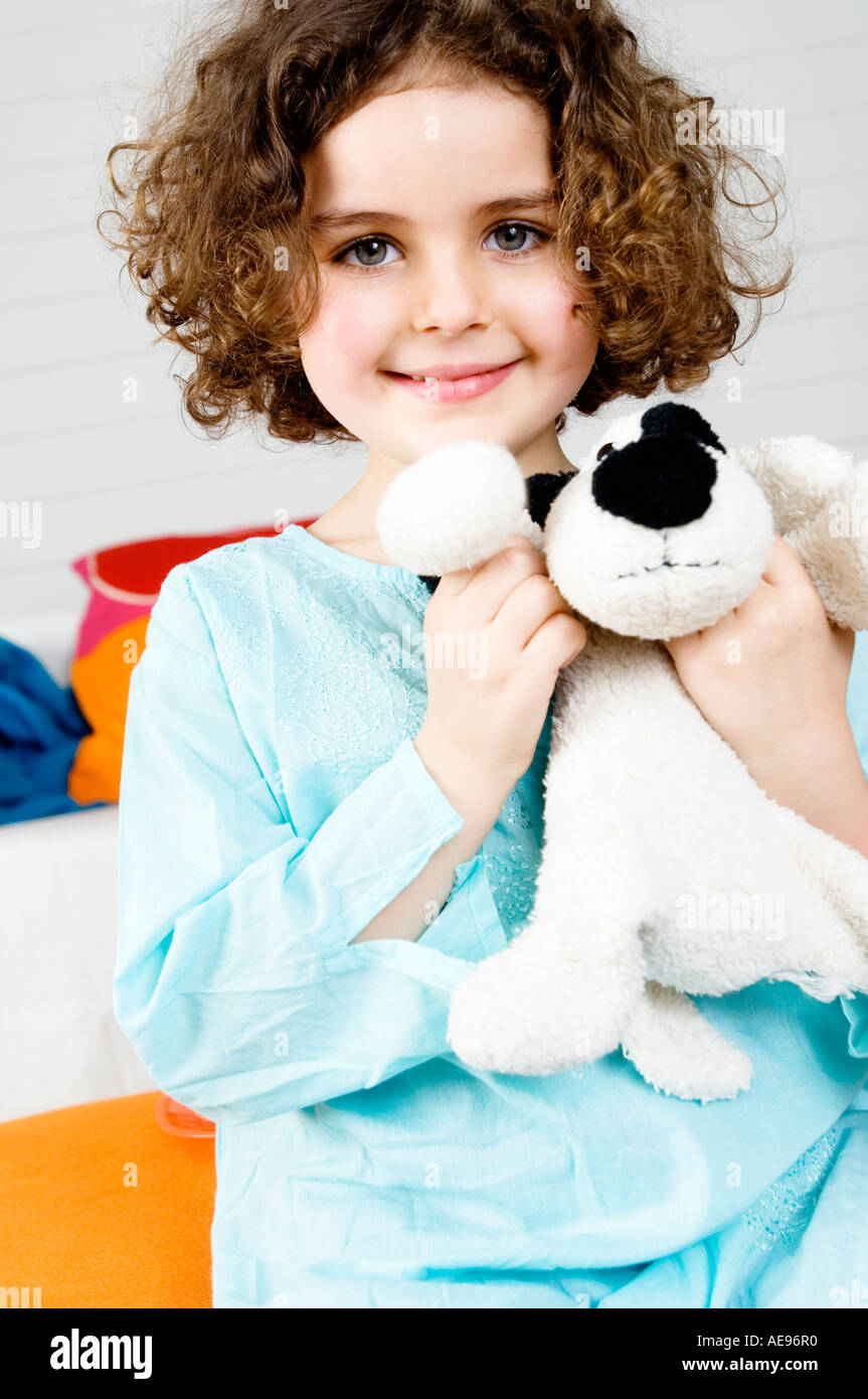 Little girl holding stuffed dog Stock Photo - Alamy