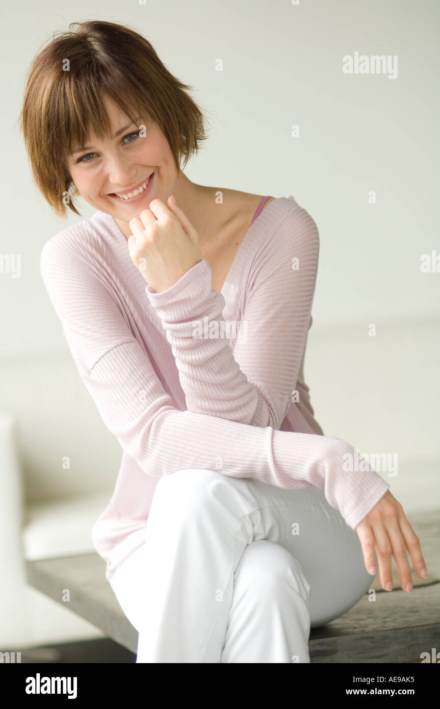 Young woman sitting on a sofa Stock Photo
