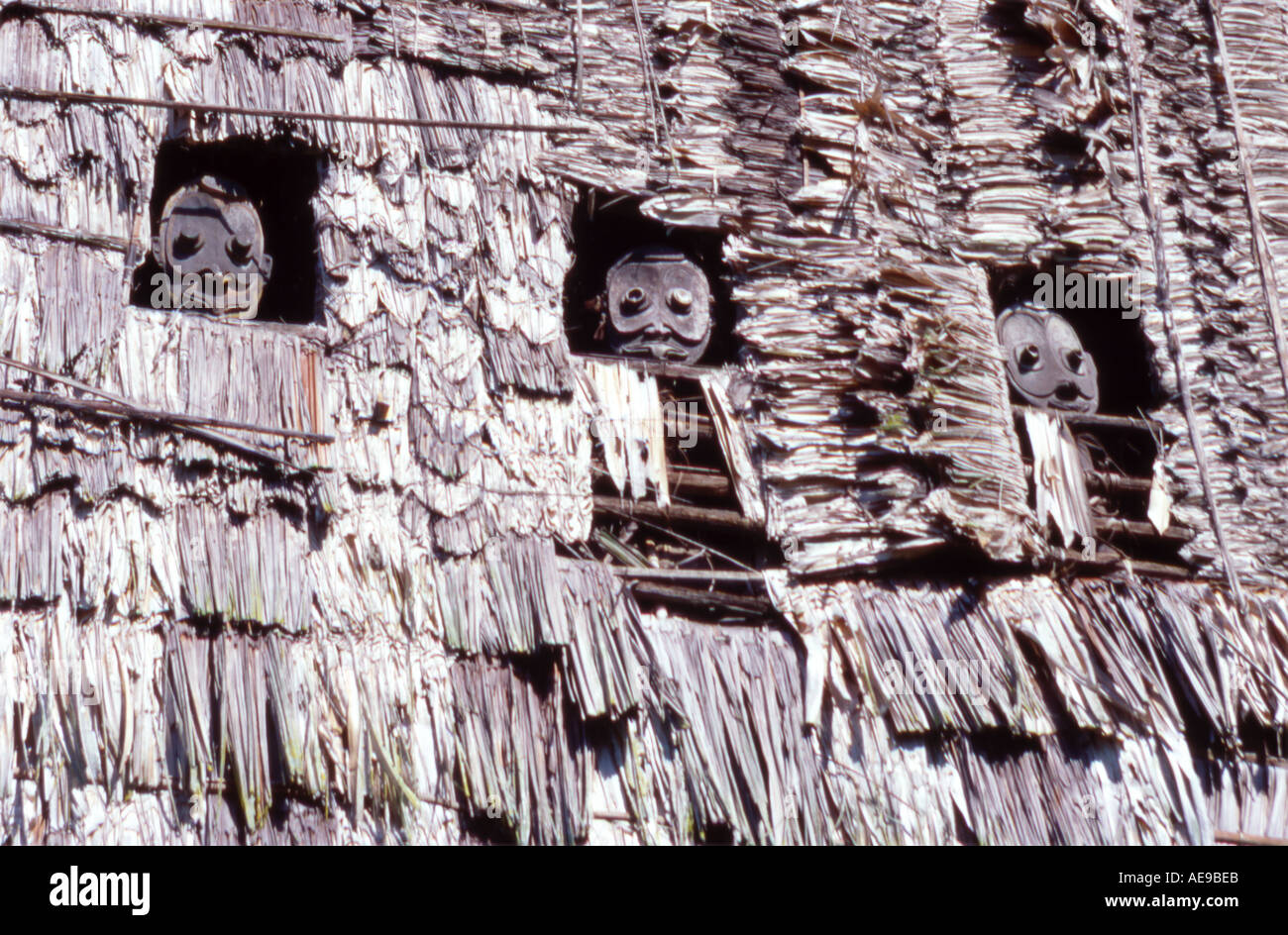 traditional sepik masks in the wall of a spirit house papua new guinea