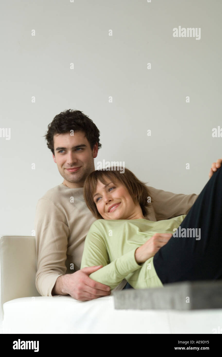 Smiling couple lying on a sofa Stock Photo