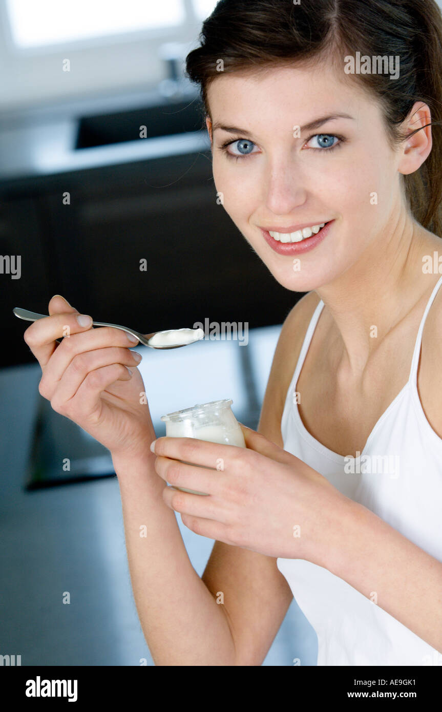 Woman Eating Yogurt Blue High Resolution Stock Photography and Images