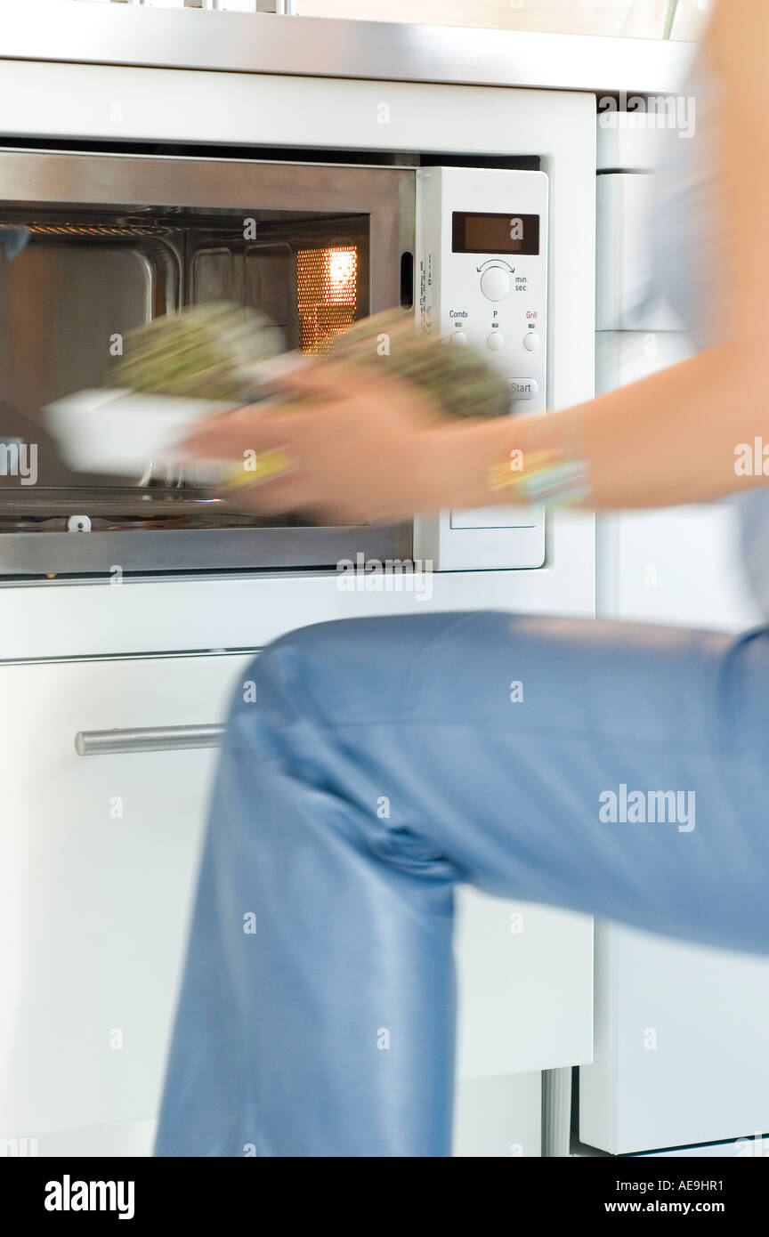 Person using microwave oven hi-res stock photography and images - Alamy