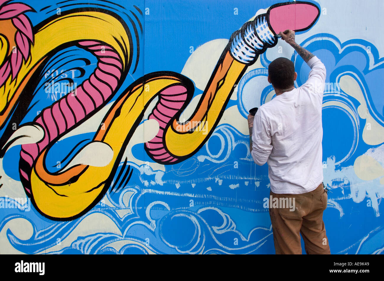 Artist painting a wall on Smith street Brooklyn NY USA Stock Photo