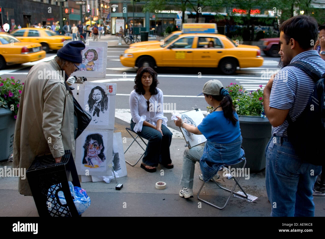 An Indian tourist having her portrait taken by a street artist Manhattan NY USA Stock Photo