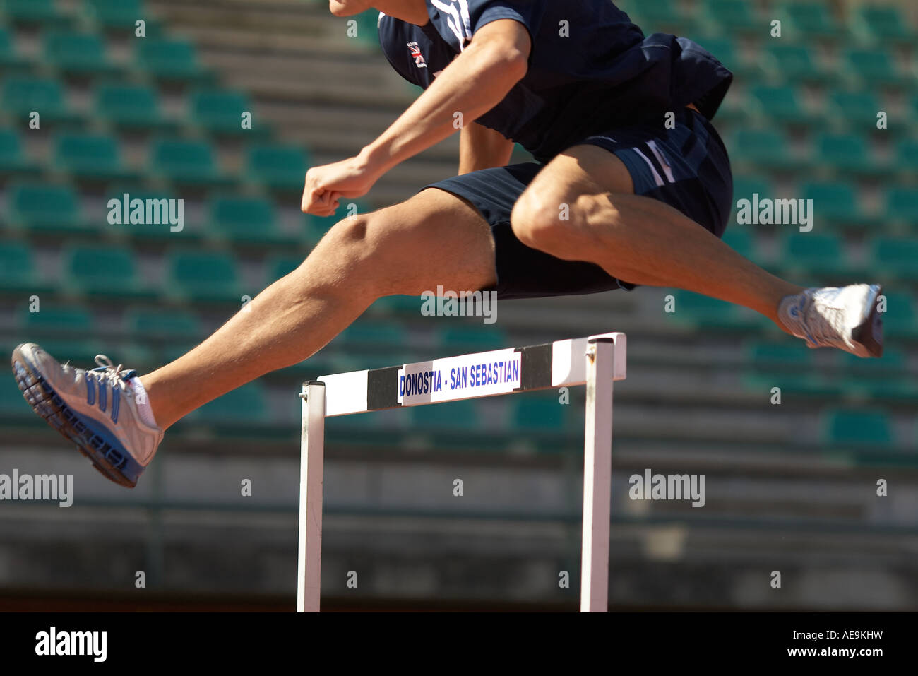 Track and field Man doing hurdles Stock Photo Alamy
