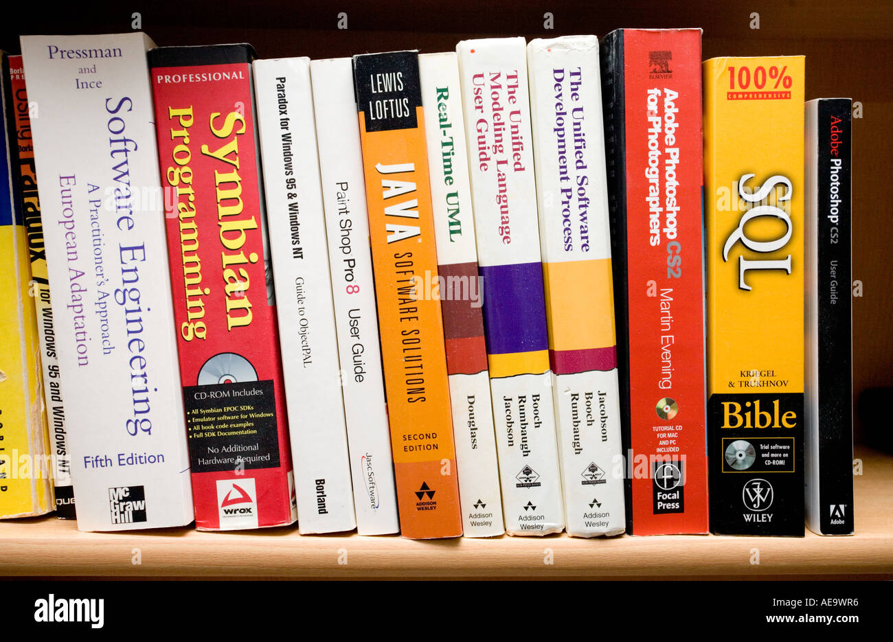 Close Up Of A Bookshelf Filled With Colorful Books Of Software