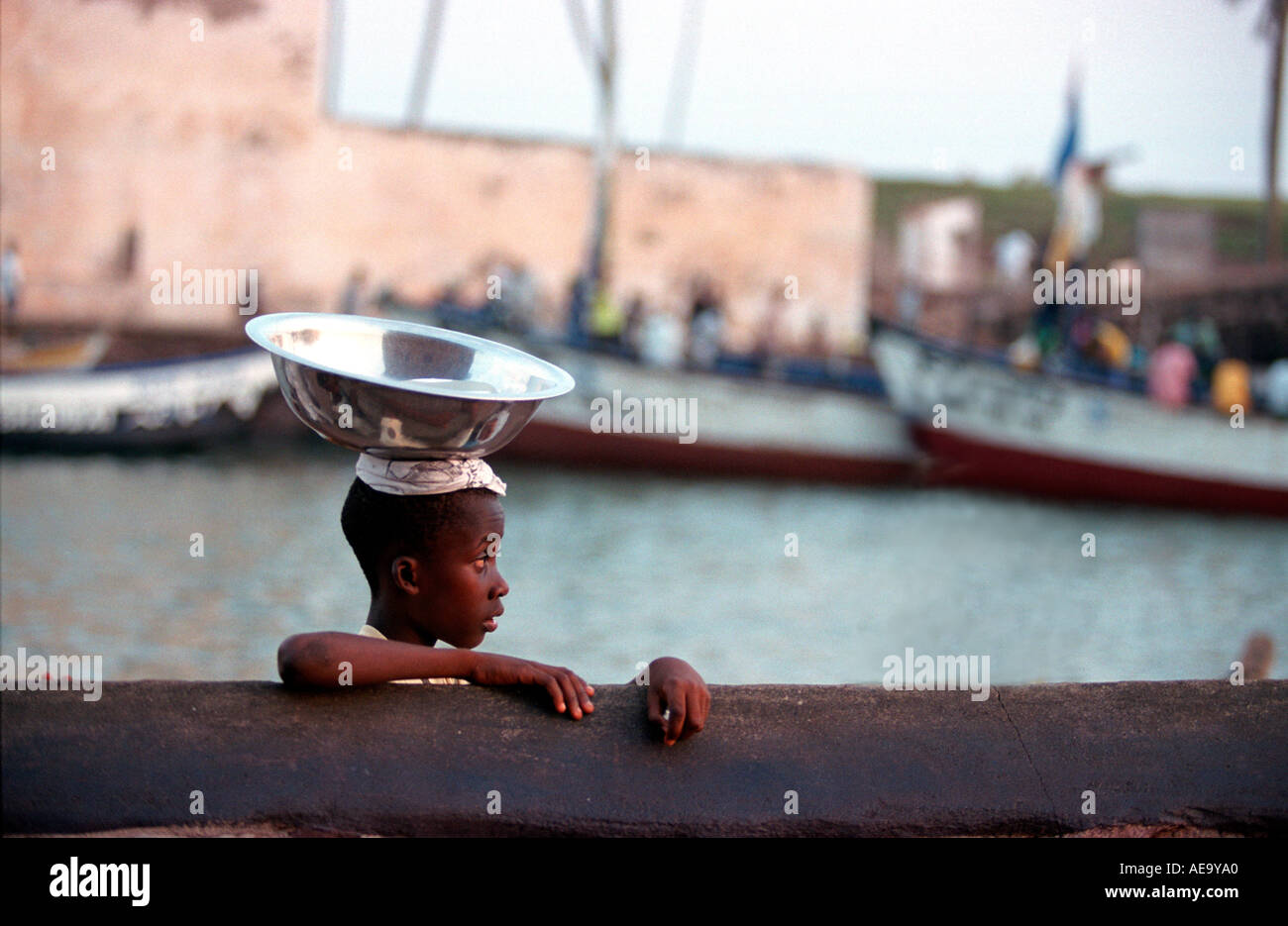 Sunset girl carrying bowl on head hires stock photography and images