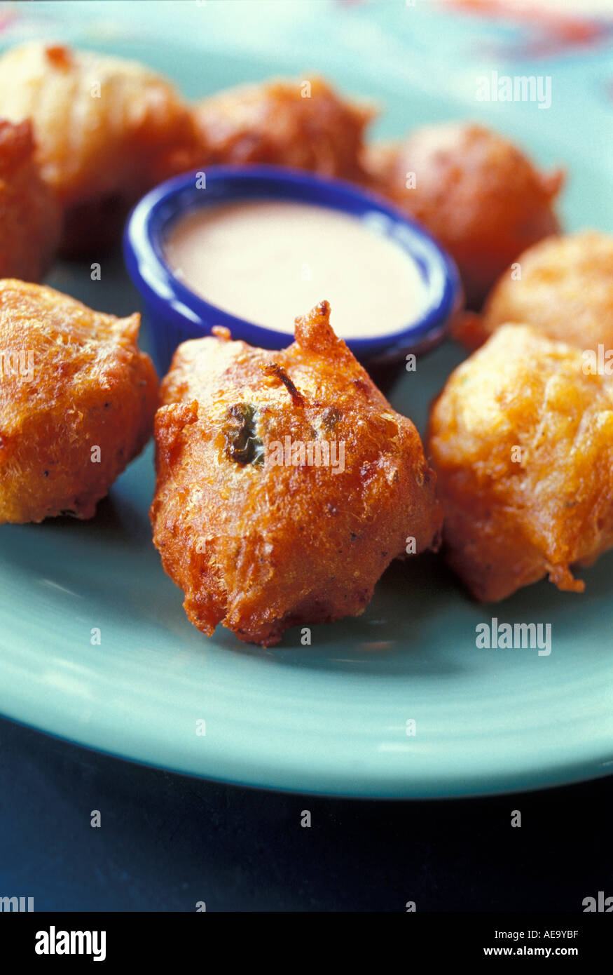 The famous dish of the Bahamas Conch fritters surround a spicy dipping sauce at Johnny Canoe s in Nassau Cable Beach Stock Photo