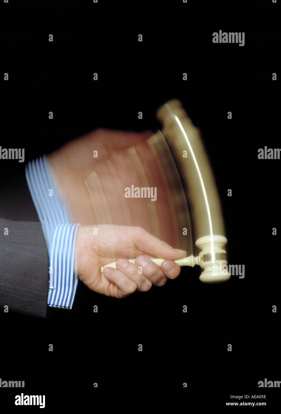 An auctioneer's gavel descends to complete a sale. Photo depicting