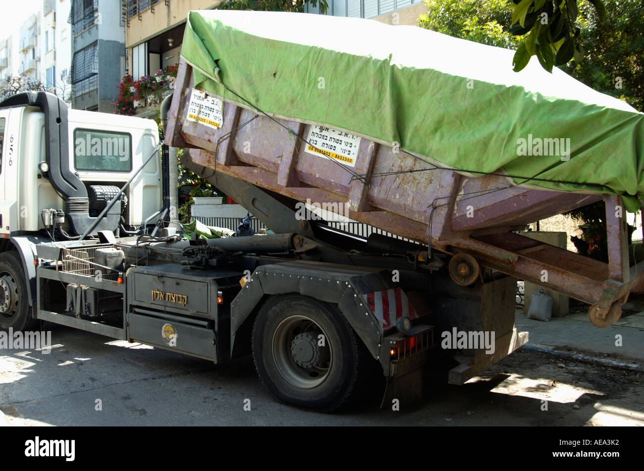 Truck loading a full covered container of building material waste Stock  Photo - Alamy