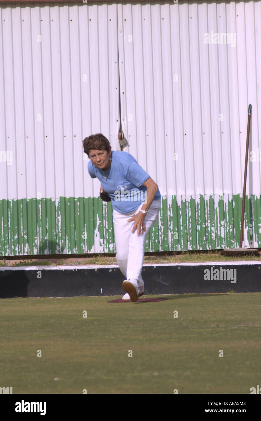 Woman delivering wood on a Lawn bowling green Model released Stock Photo