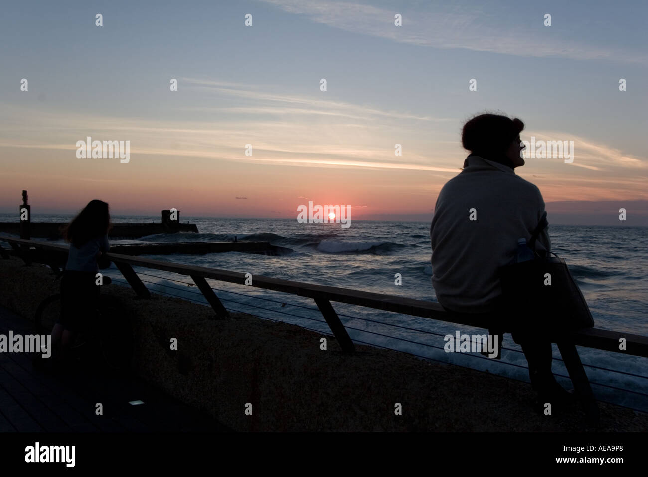 A silhouette of a person at Sunset Stock Photo