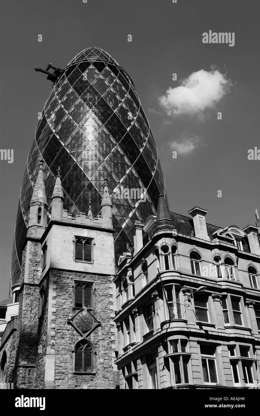 Swiss Re Tower or the Gherkin and St Andrew Undershaft Church in the City of London Stock Photo