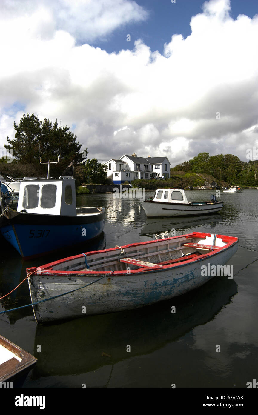 Small fishing boats moored outside the Heron's Cove hotel Goleen Ireland Stock Photo
