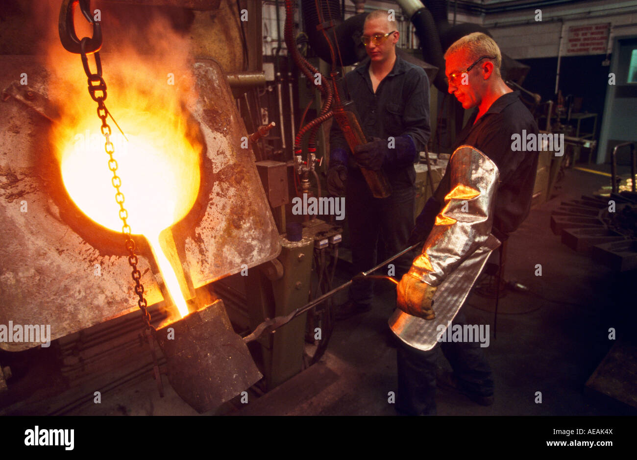 Pouring gold into crucible for final purifying, Perth, Western Australia, horizontal, Stock Photo
