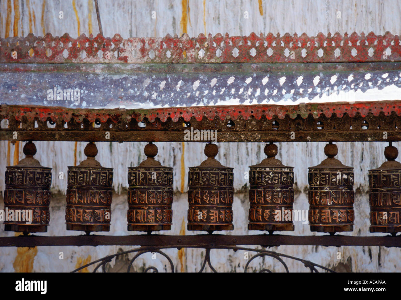 Ornately carved Buddhist prayer wheels at Swayambhunath Stupa Buddhist monument in Nepal Stock Photo