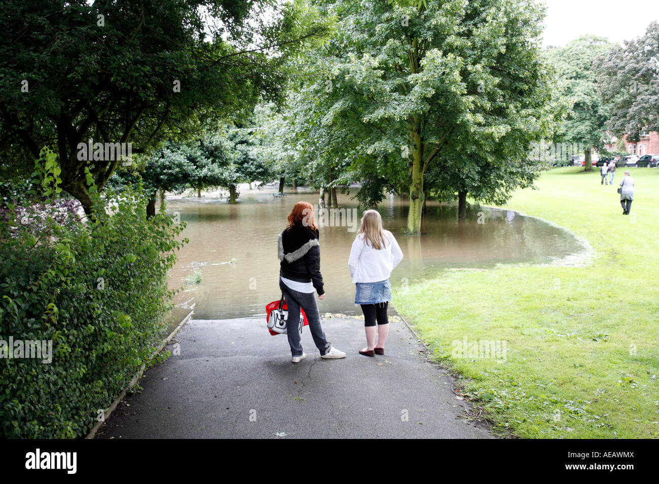 Teenage Girls Look at Flooded Street and Park, Leamington Spa, Warwickshire  July 2007 Stock Photo