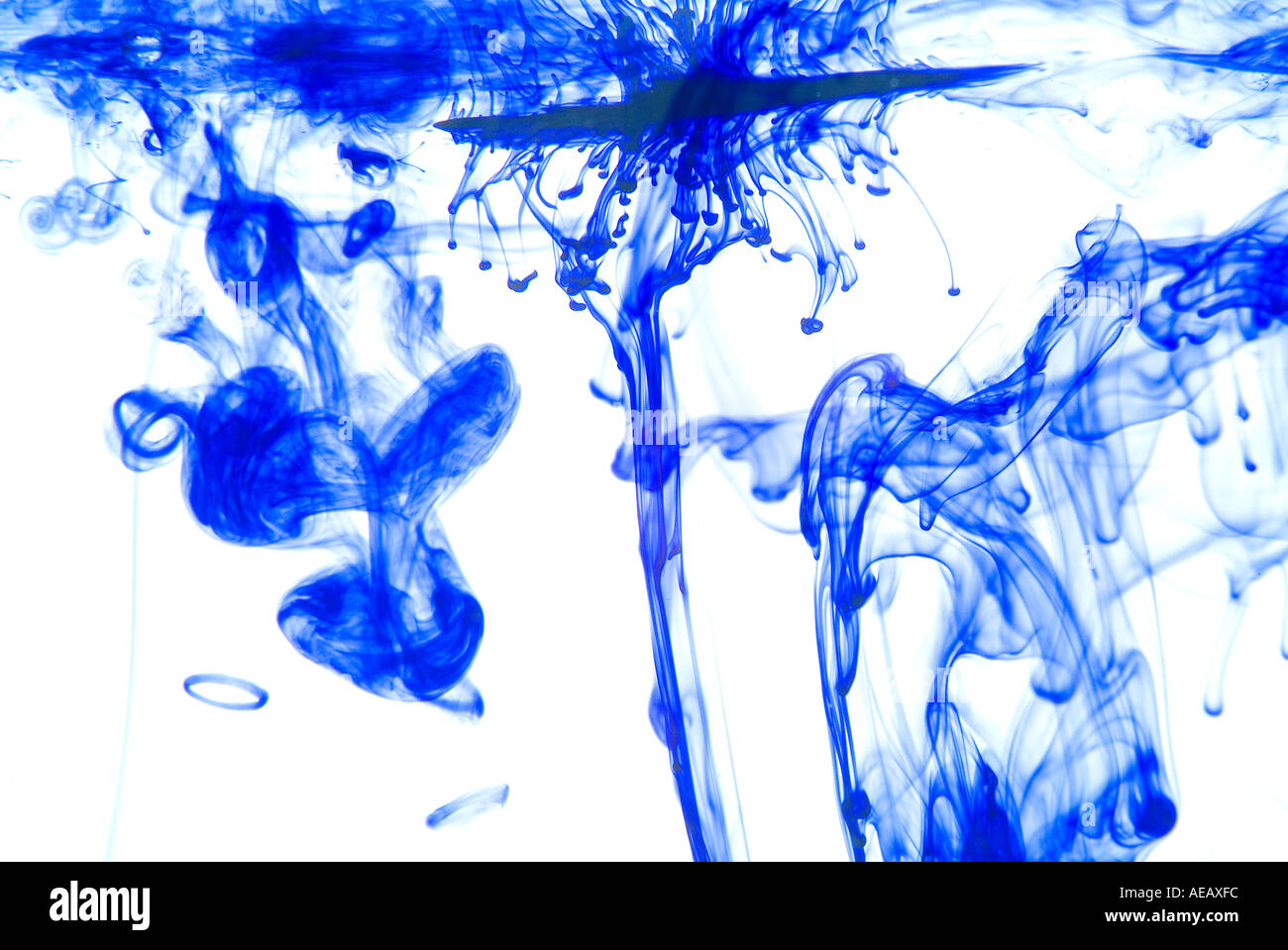 Coloured ink in water creating graphic swirling patterns Stock Photo ...