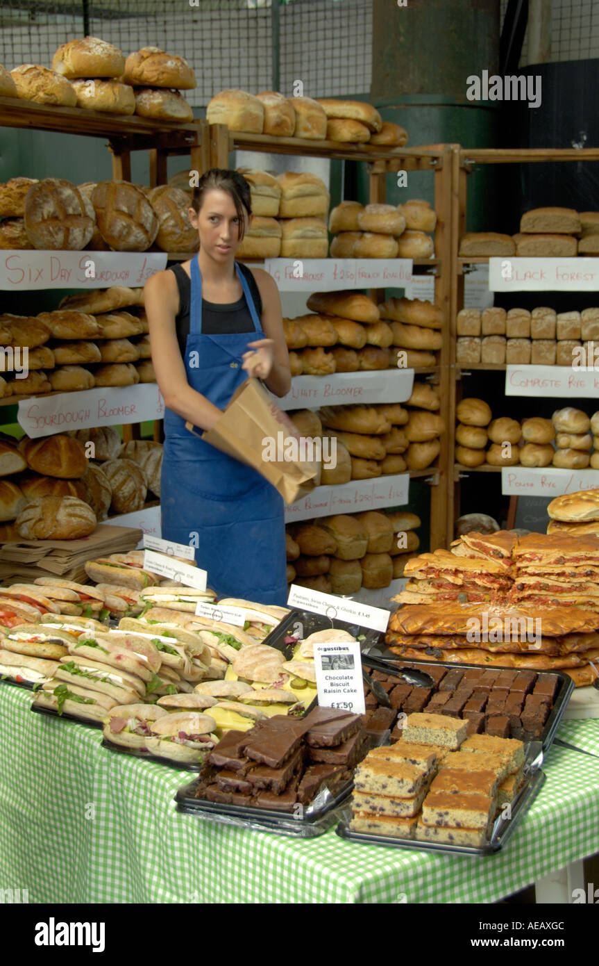 Young girl selling bakery produce Burough Market London Stock Photo