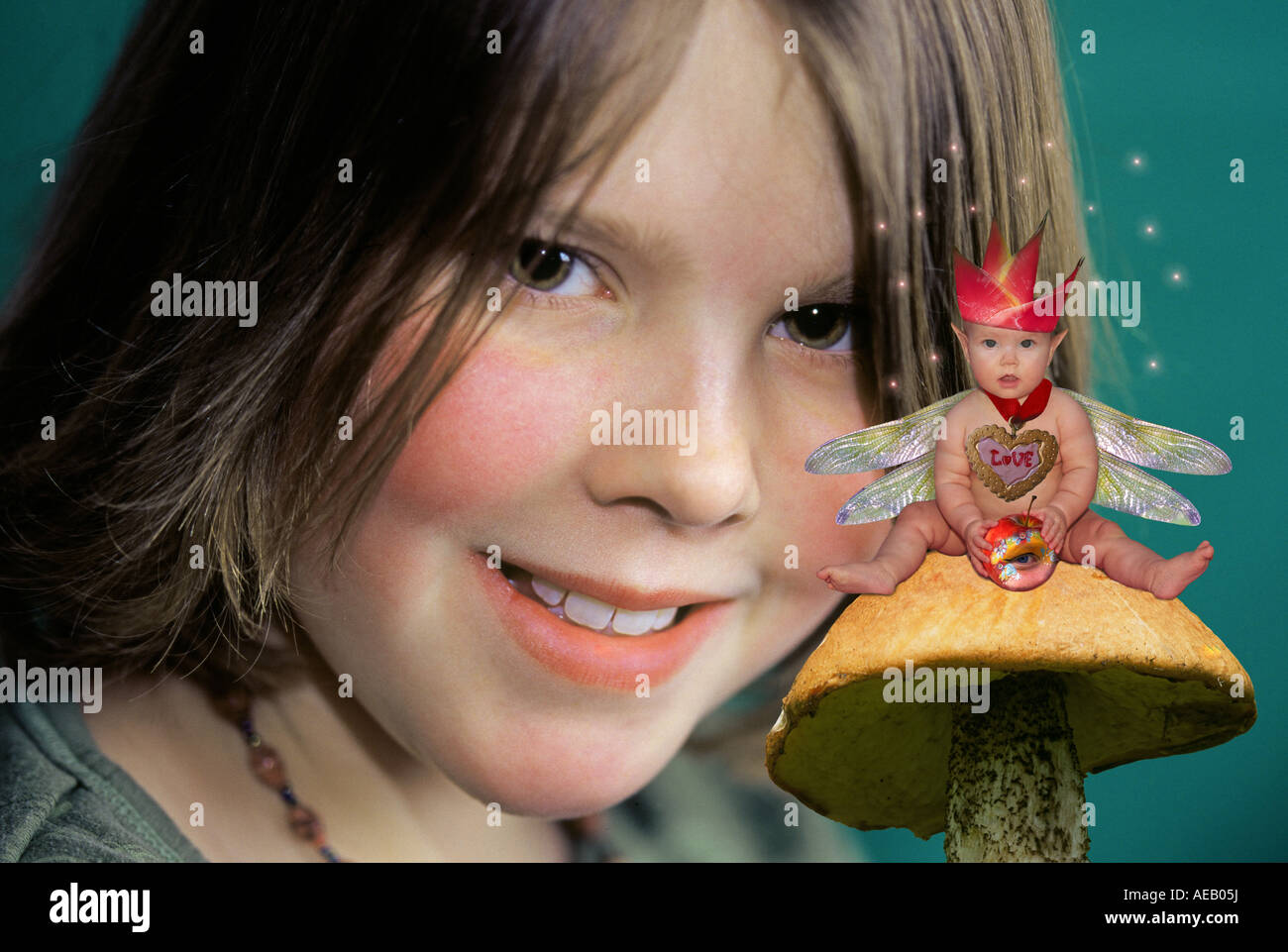 A flower fairy on a mushroom meets a little girl Stock Photo