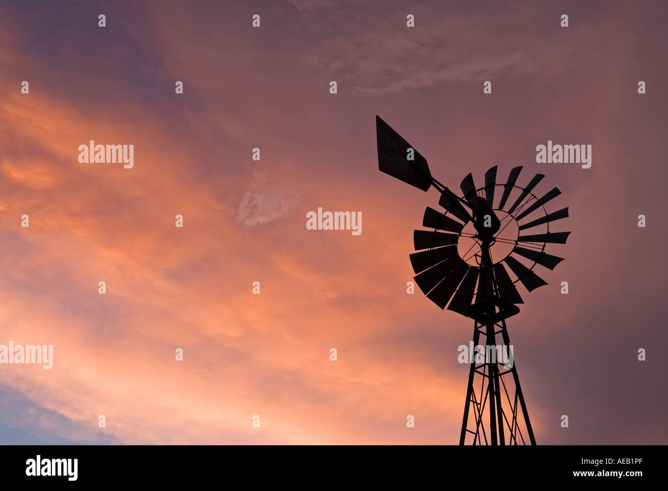 Windmill silhouetted at sunset on the Great Plains, Texas, USA Stock Photo
