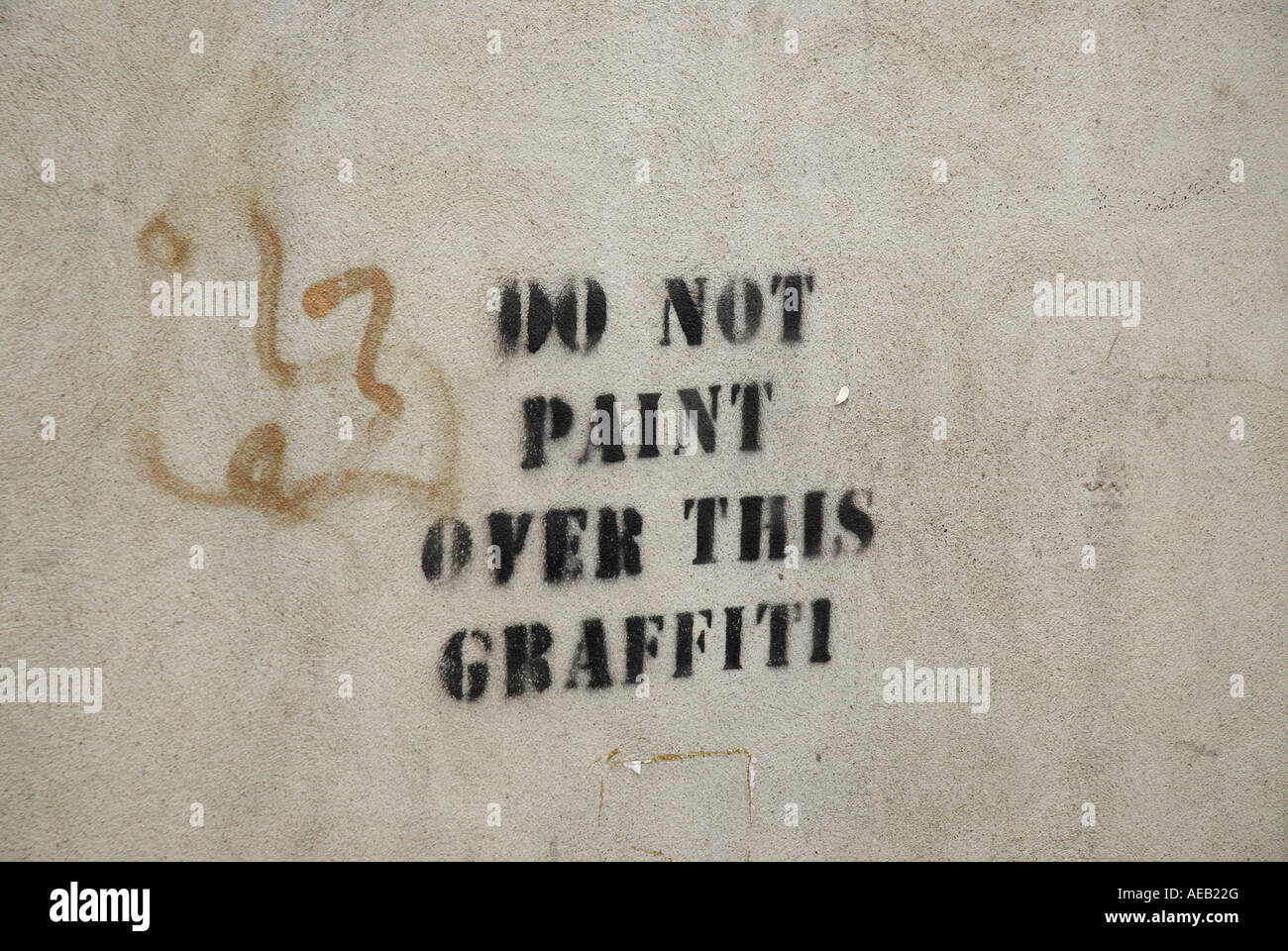Stenciled Sign Do Not Paint Over This Graffiti on a Concrete Wall Stock