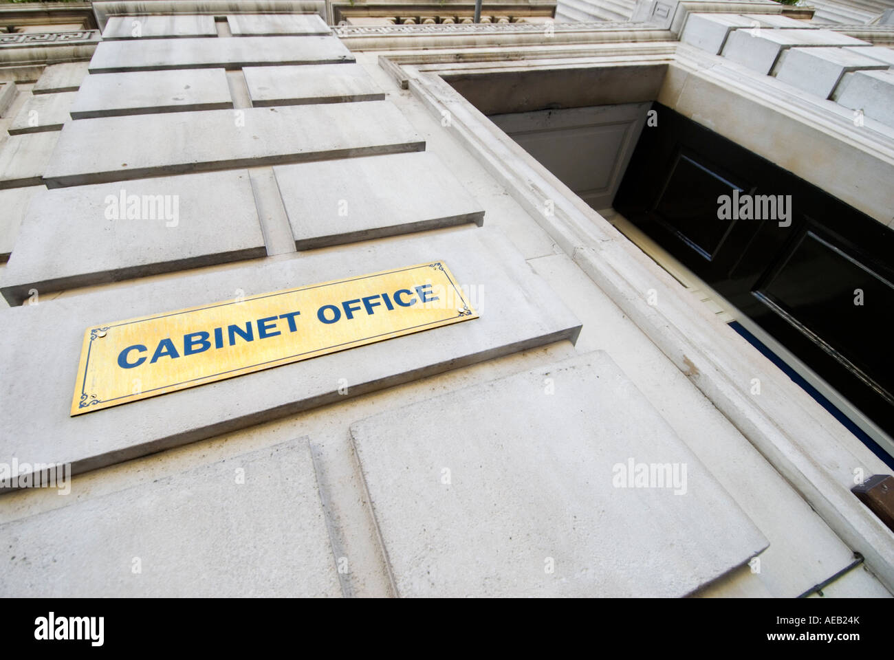 Brass name plaque and entrance to the Cabinet Office in Whitehall Central London UK Stock Photo
