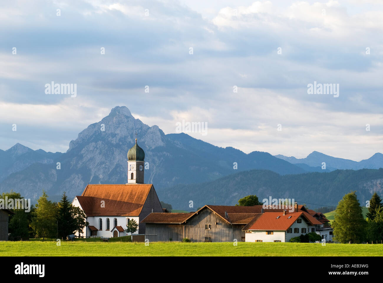 classic architecture of small Bavarian church and alps of Allgaeu region in early morning, Speiden, Bavaria Germany Stock Photo