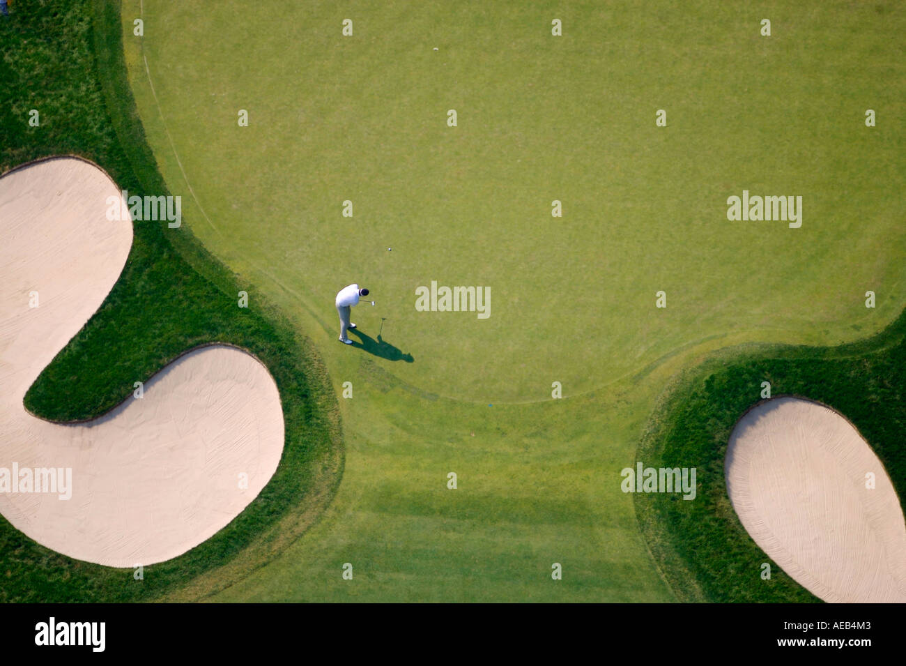 Golfer putting as seen from overhead Stock Photo