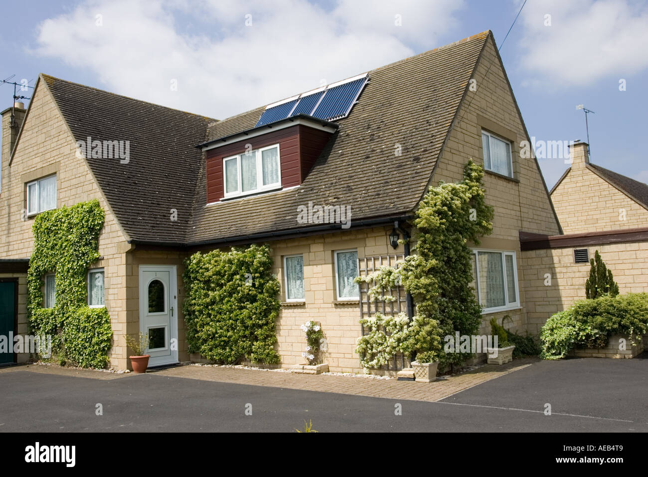 Modern solar thermal hot water panels with evacuated tubes on roof of ...