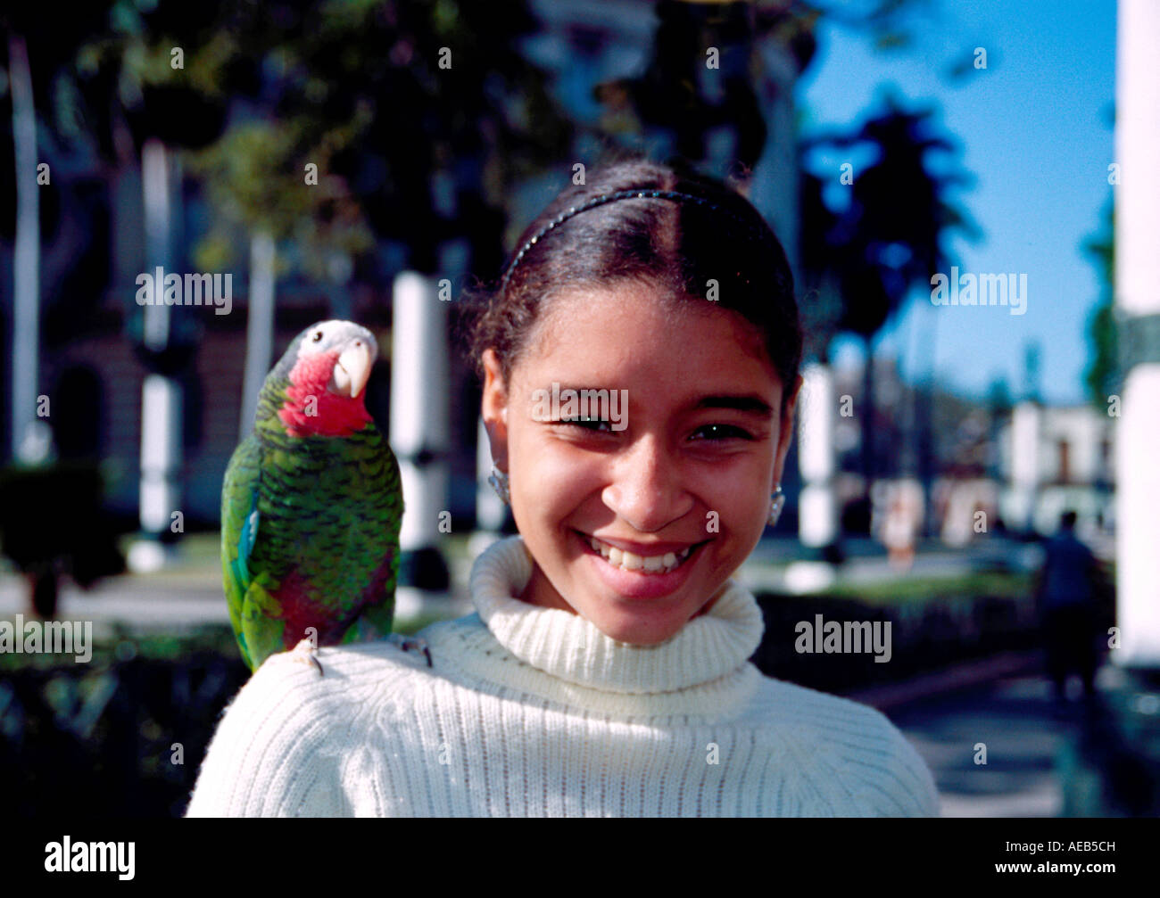 Girl with a parrot on his shoulder in Havana Cuba Stock Photo