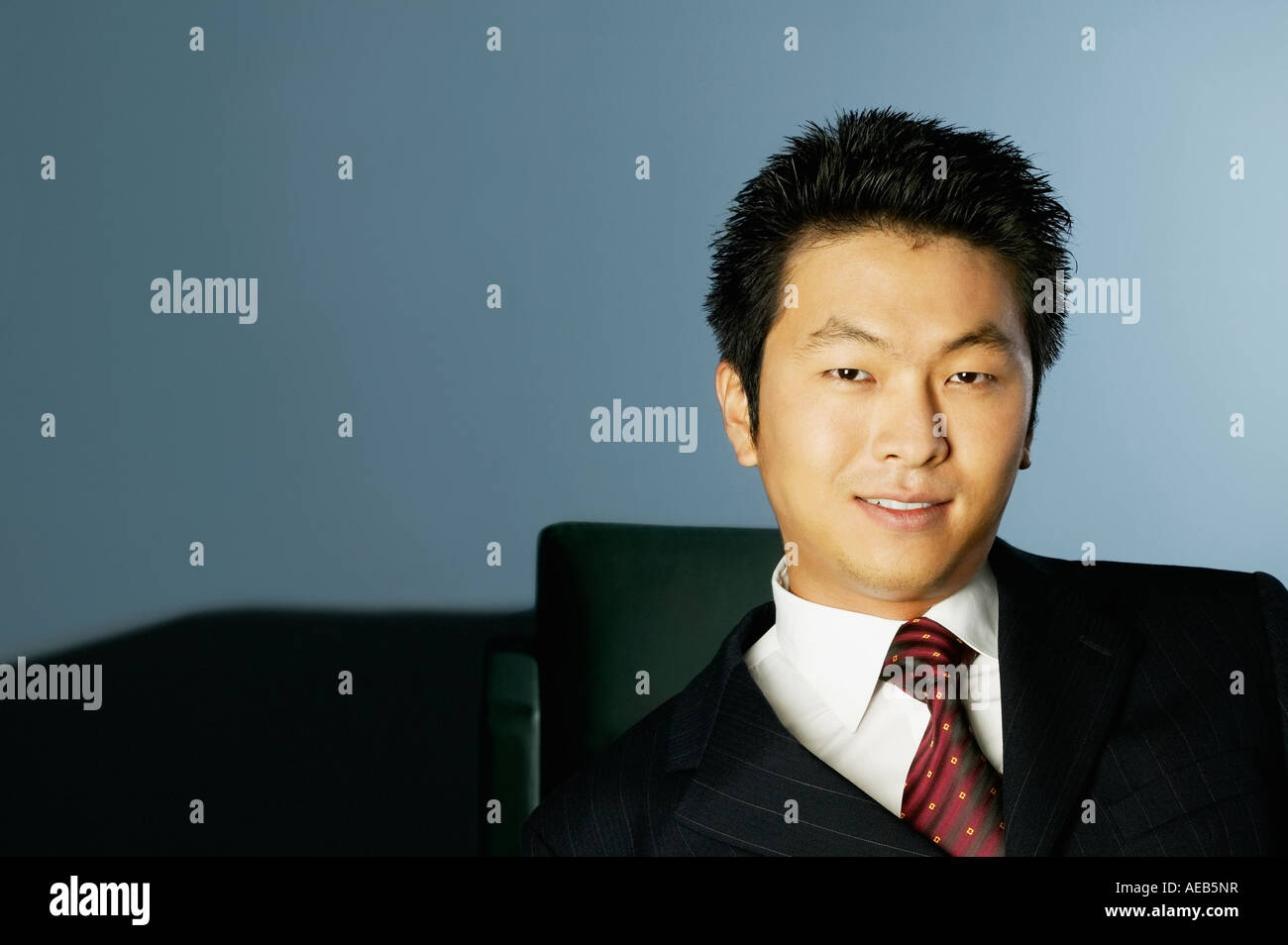 Young Asian businessman smiling Stock Photo - Alamy