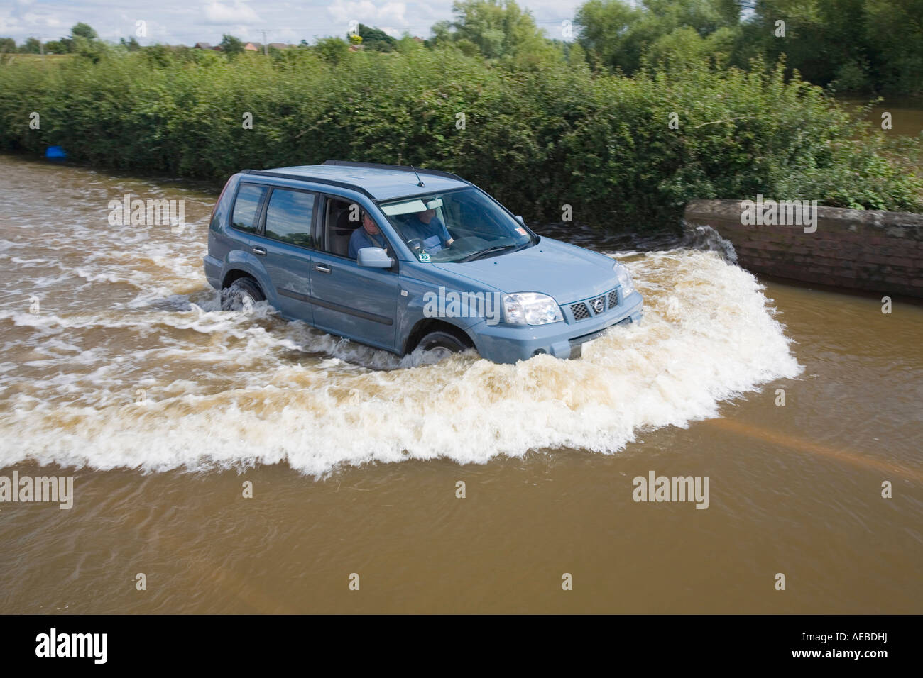 A car driving through floodwaters near Upton upon Severn Stock Photo