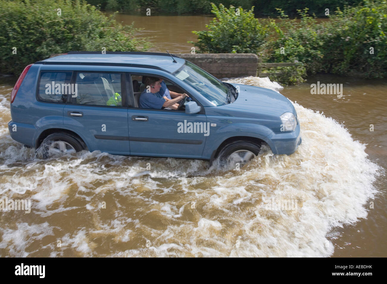 A car driving through floodwaters near Upton upon Severn Stock Photo