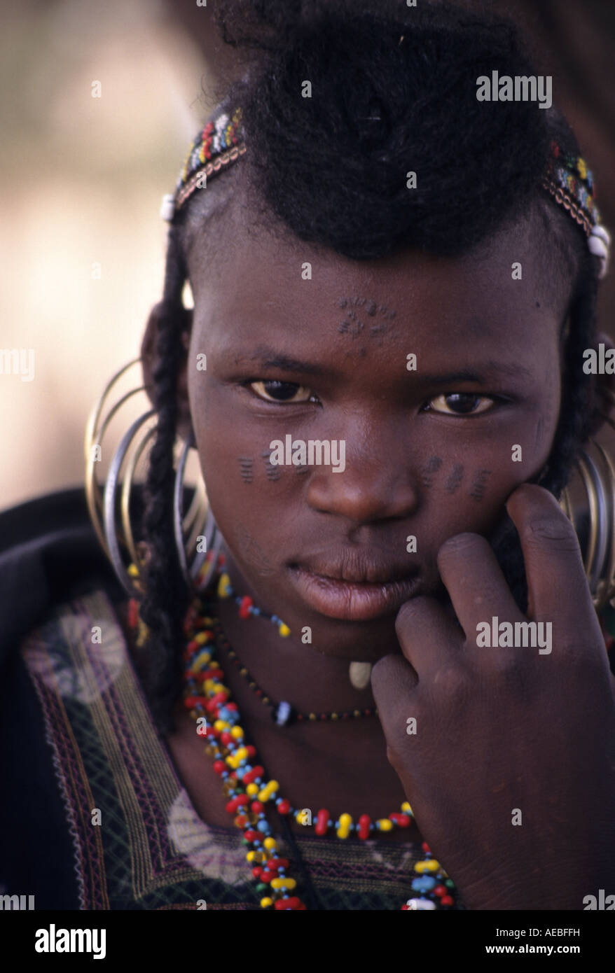 Akadaney, Niger. Fulani Girl with Facial Tattoos, Jewelry, Ear Rings Stock Photo
