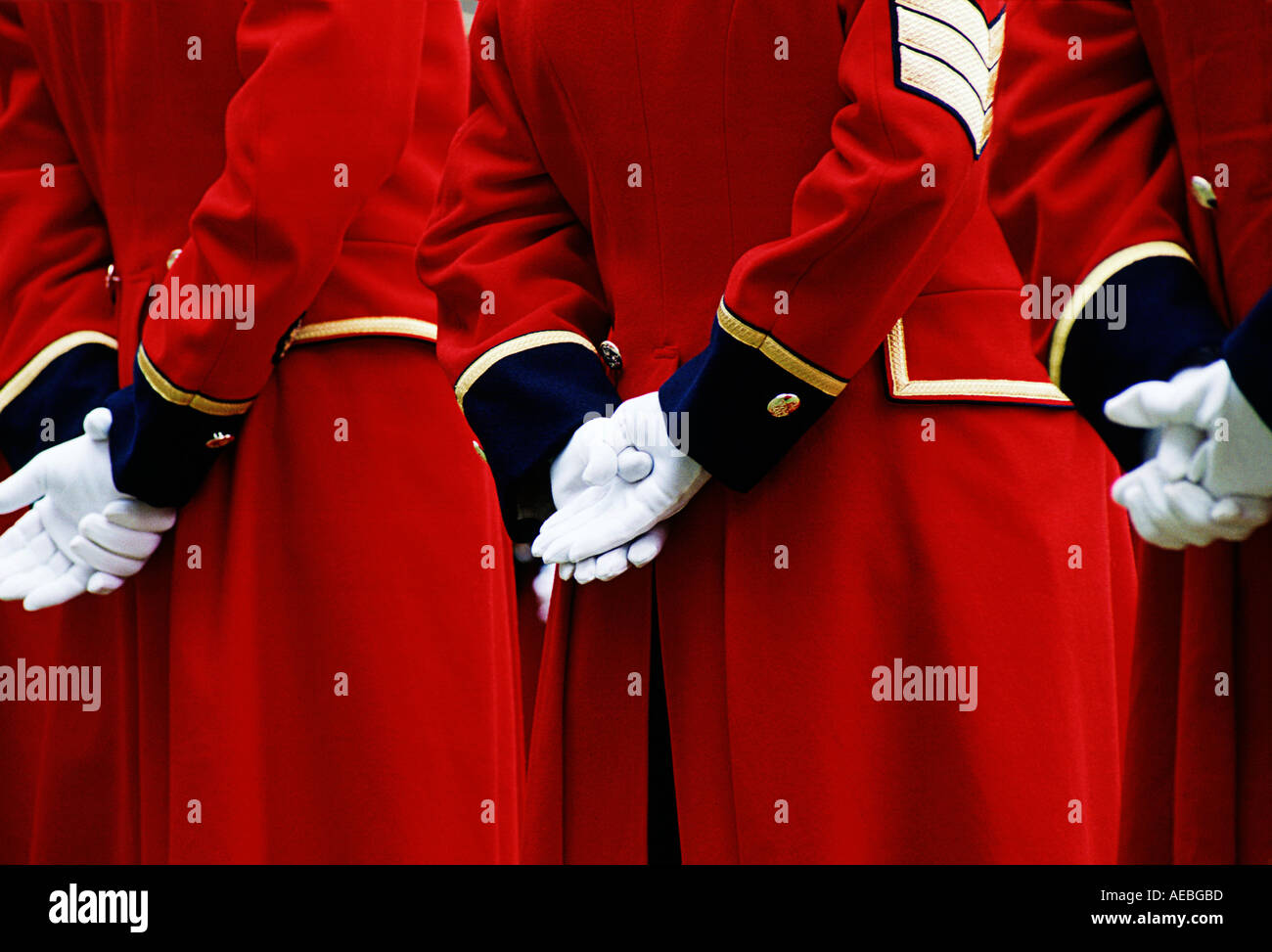 Details of traditional red coat uniforms black cuffs and white gloves of Chelsea Pensioners London Stock Photo