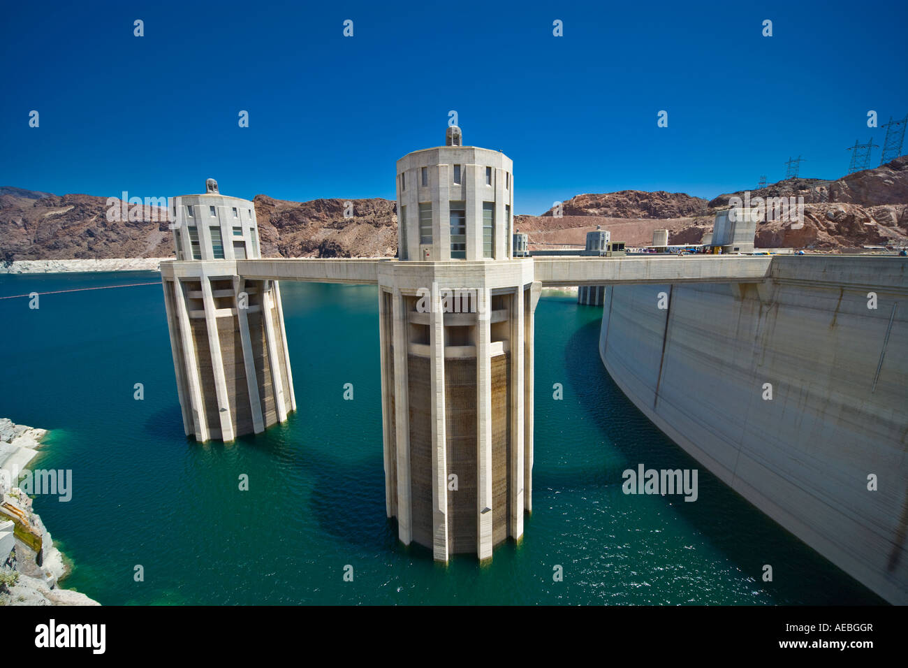 Hoover or Boulder Dam intake or penstock towers on the Nevada side. Lake Mead with extreme low water level. Stock Photo