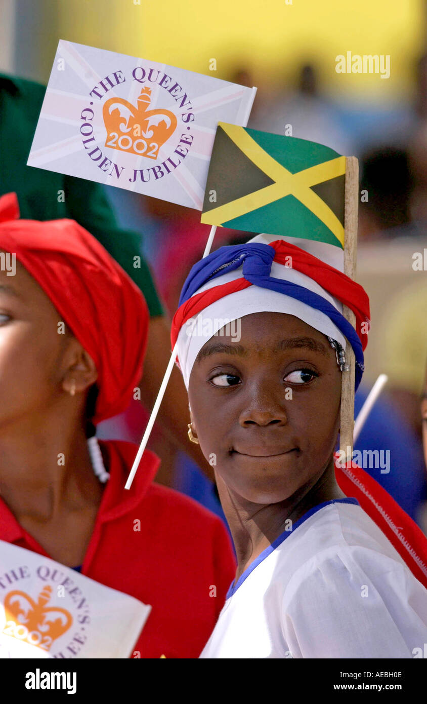 Young girl with a Queen s Jubilee flag and the Jamaican National Flag slotted through her headband Jamaica Stock Photo
