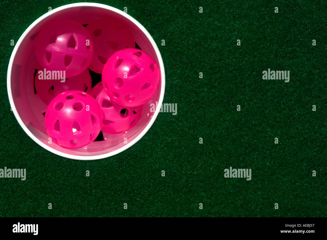 Plastic practice golf balls in a putting hole. picture by Patrick Steel www patricksteel co uk