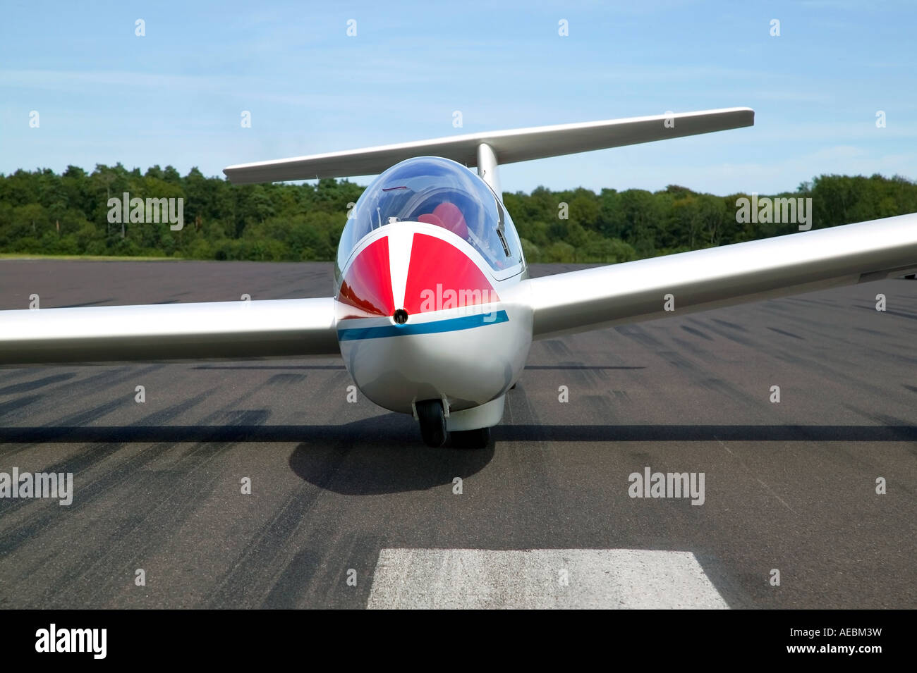 Glider at rest on a tarmac runway Stock Photo