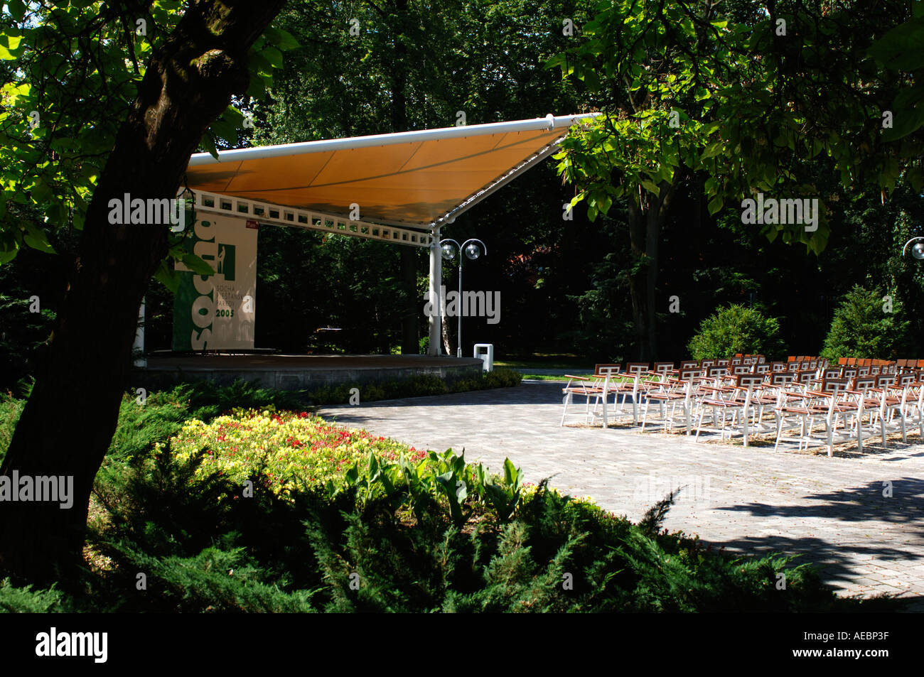 empty stage ready for a performance located in a green bright park Stock Photo