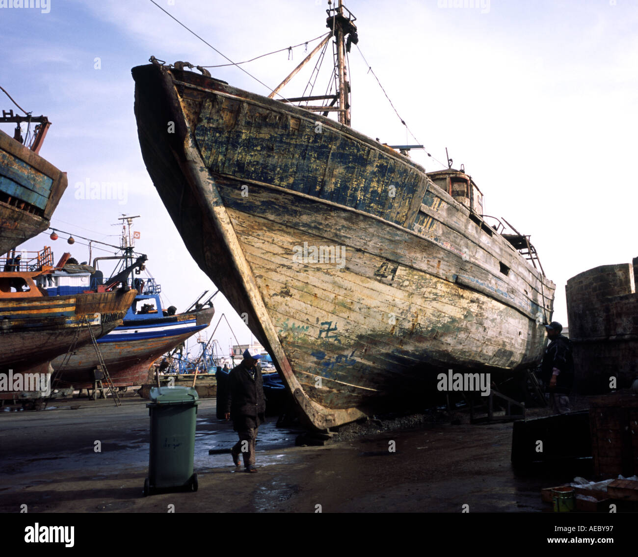 The rotting hull of a trawler is clearly visible in the shipyard of essaouira harbour A swastika has been written on the hull  Stock Photo
