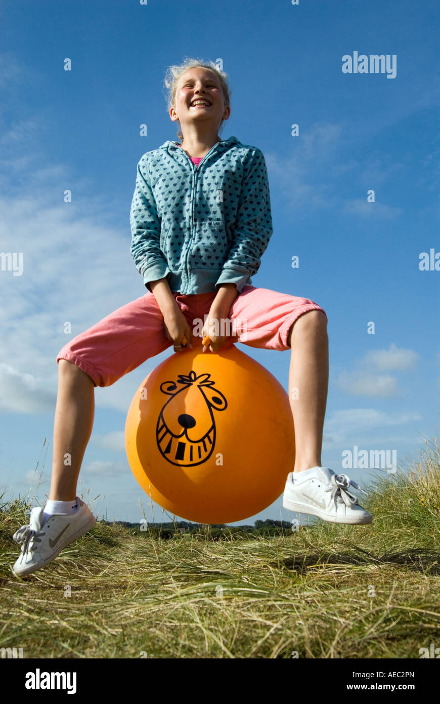 Young girl bouncing on a Space Hopper England UK Stock Photo