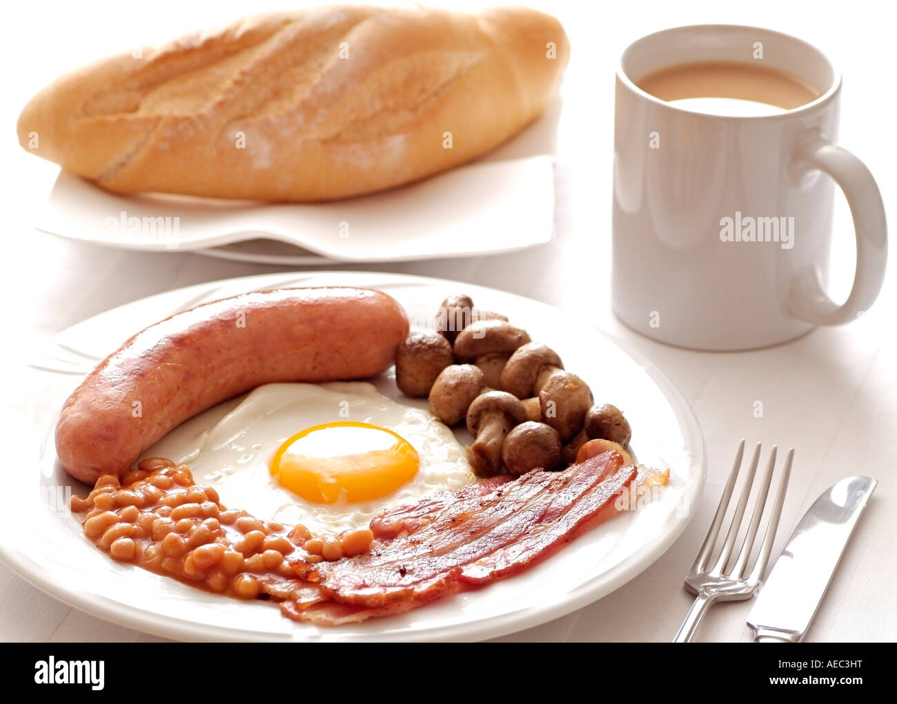 Traditional English Cooked Breakfast of Sausage Egg Bacon Mushrooms and