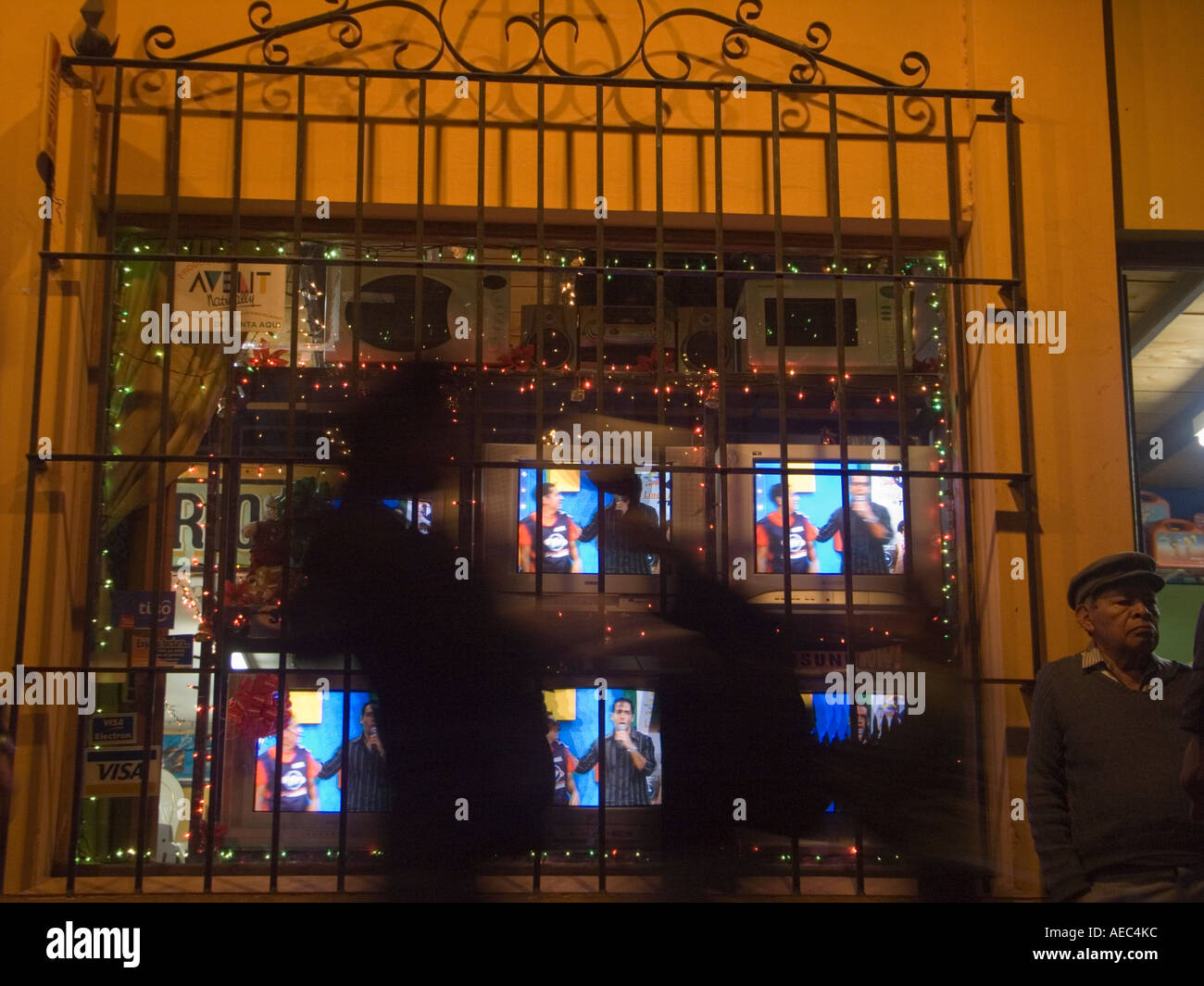 Guatemalans shop for or walk buy TVs for sale in an appliance store Stock Photo